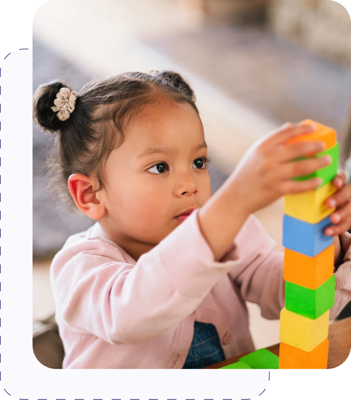 Child stacking colorful blocks
